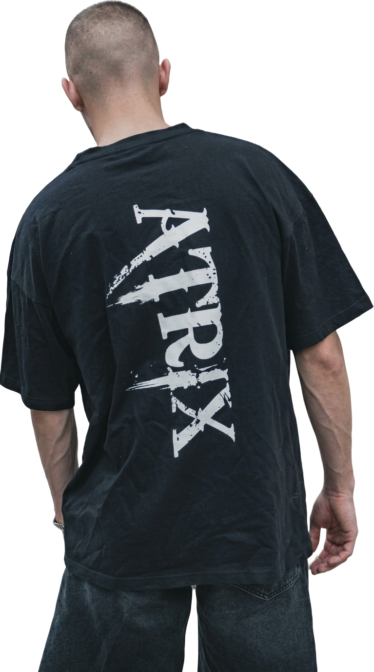 Model wearing the ATRIX Drop 01 oversized black tee, seen from behind